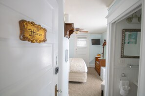 Relax in a cozy space with a comfortable bed, dresser, and TV.