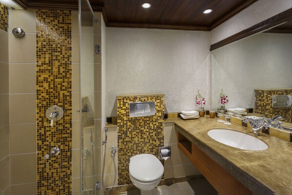 A bathroom with two sinks, a toilet, and a shower. - Lazy Lagoon, Baga A Lemon Tree Resort (Arpora)