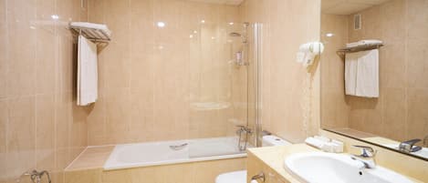 A modern bathroom with a bathtub, toilet, and sink.