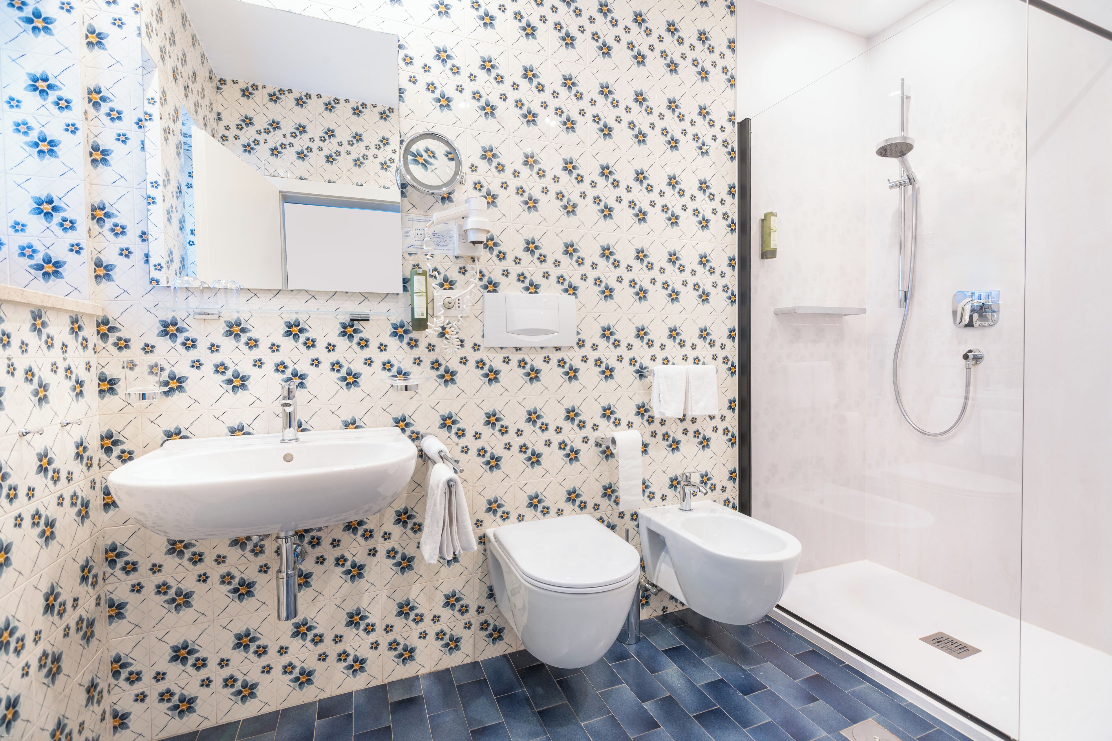 A bathroom with a sink, toilet, and shower.