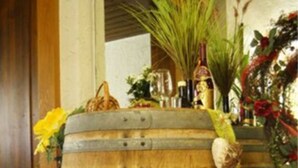 A rustic wooden barrel used as a decorative piece with flowers and bottles. - Hotel Altenberg (Baden-Baden)