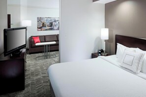 A hotel room with a large bed, a flat-screen TV, a sofa, a small table, and a painting on the wall. - SpringHill Suites by Marriott Columbus (Columbus)