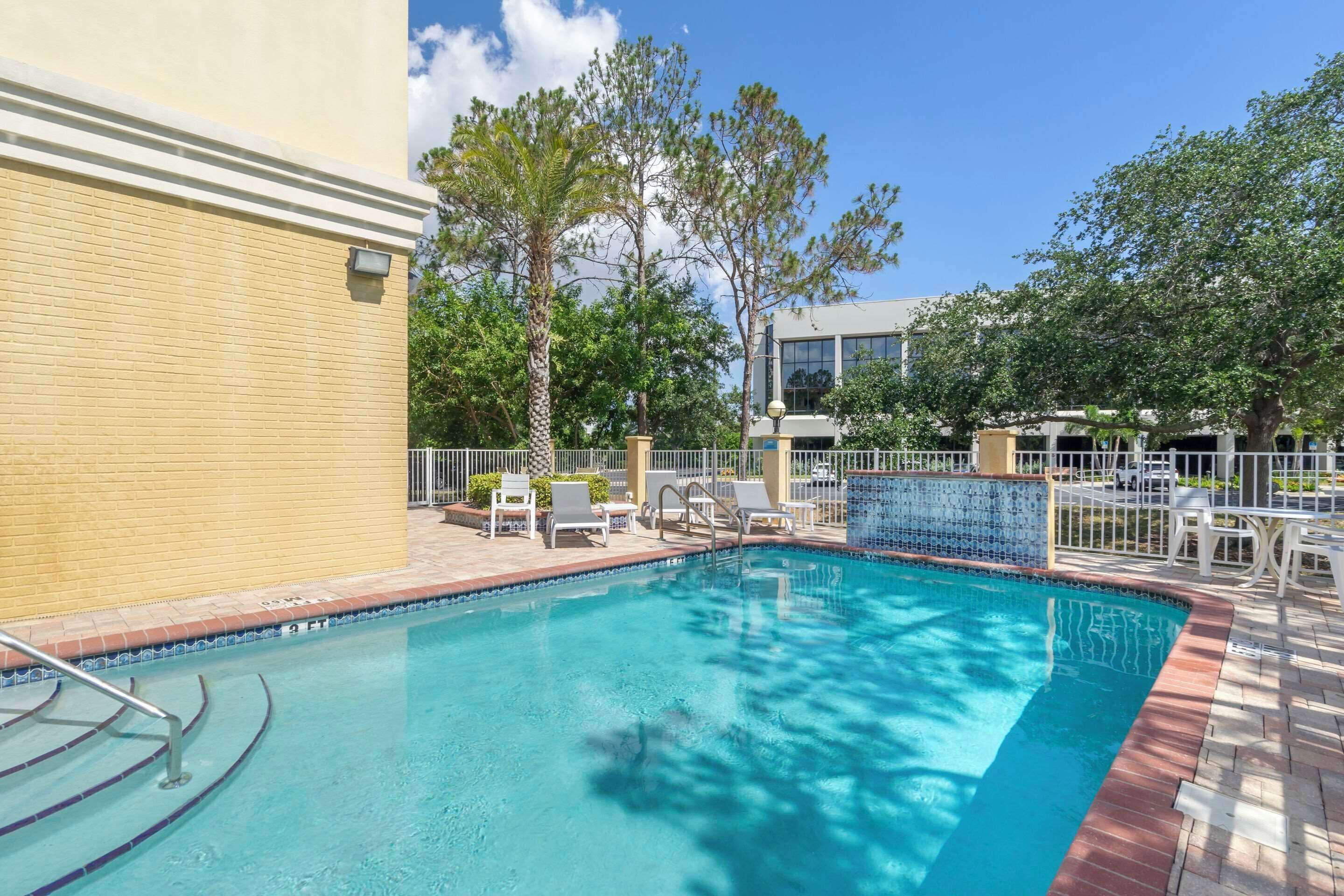 outdoor pool, open 8:00 am to 10:00 pm, pool umbrellas, pool loungers