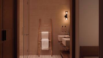 Enjoy a refreshing shower in the sleek bathroom with a glass enclosure, sink, and wall-mounted light.