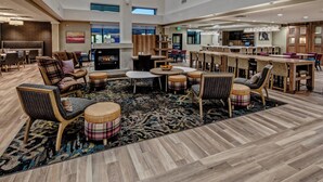 A spacious lobby with a central seating area, a fireplace, and a bar/lounge area. - Residence Inn by Marriott Nashville at Opryland (Nashville)