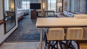 A hotel room with a large bed, a desk with a computer, a TV, a sofa, and a dining area with chairs. - Residence Inn by Marriott Nashville at Opryland (Nashville)
