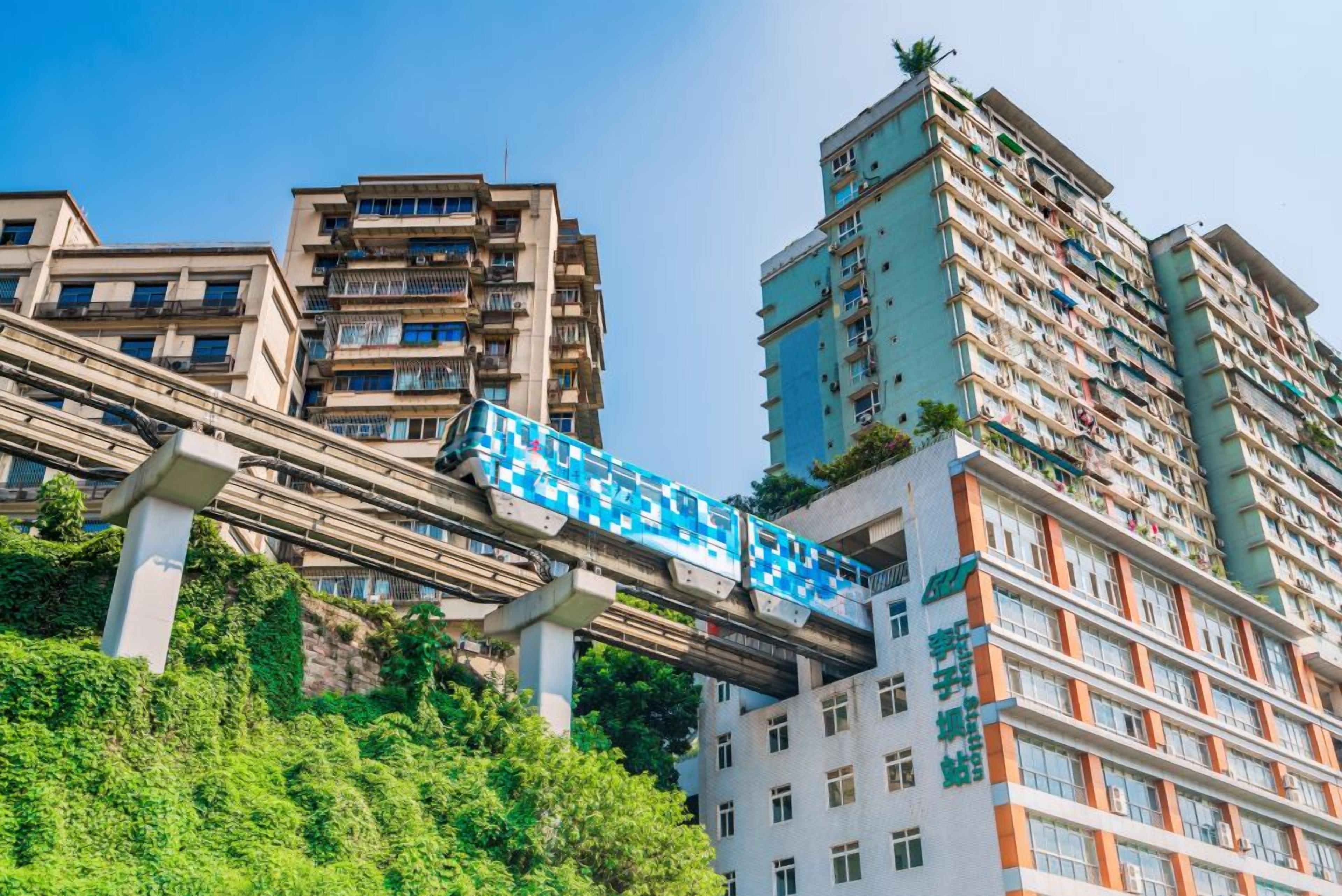A multi-story residential building with balconies and a pedestrian bridge.