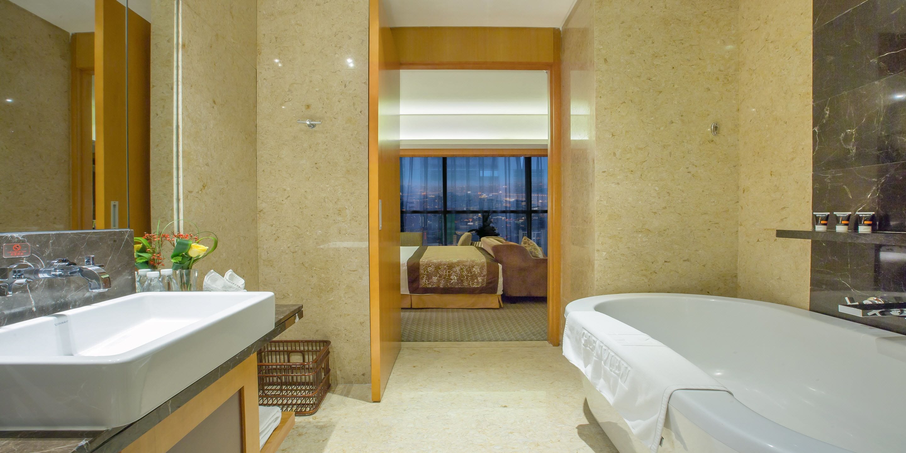 Een moderne badkamer met een groot bad, een aparte douche en een wastafel met spiegel.