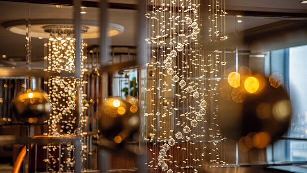 A modern interior with hanging crystal decorations and reflective surfaces. - Crowne Plaza Wuxi City Center by IHG (Wuxi)