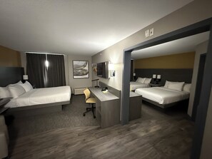 A hotel room with two beds, a desk, a chair, a TV, and a painting on the wall. - Days Inn by Wyndham Stony Plain (Stony Plain)