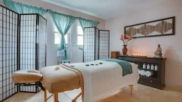 Experience a serene retreat with a traditional Japanese aesthetic, featuring a low bed, massage table, and a desk with a lamp.