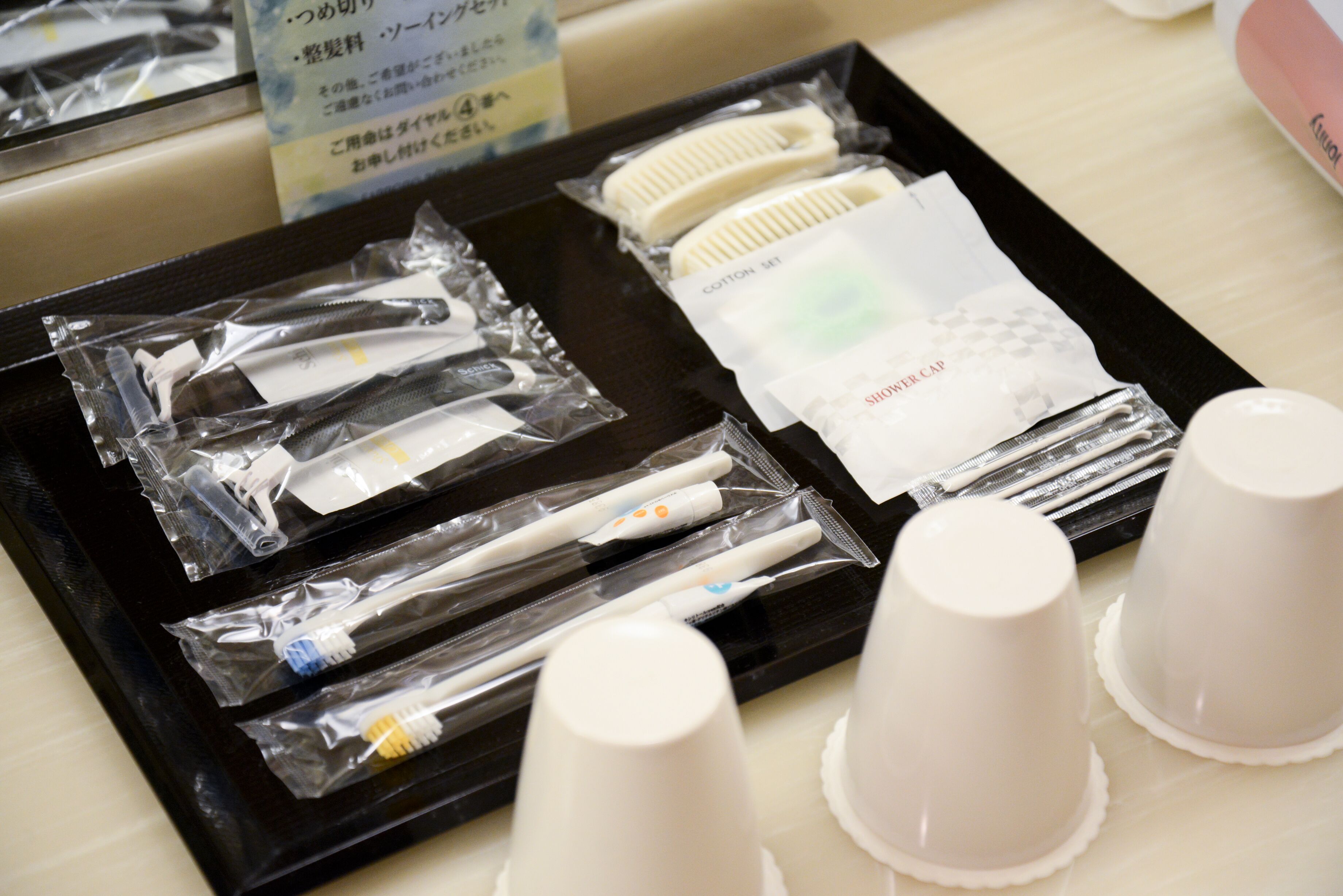 A tray with dental care items and disposable cups.