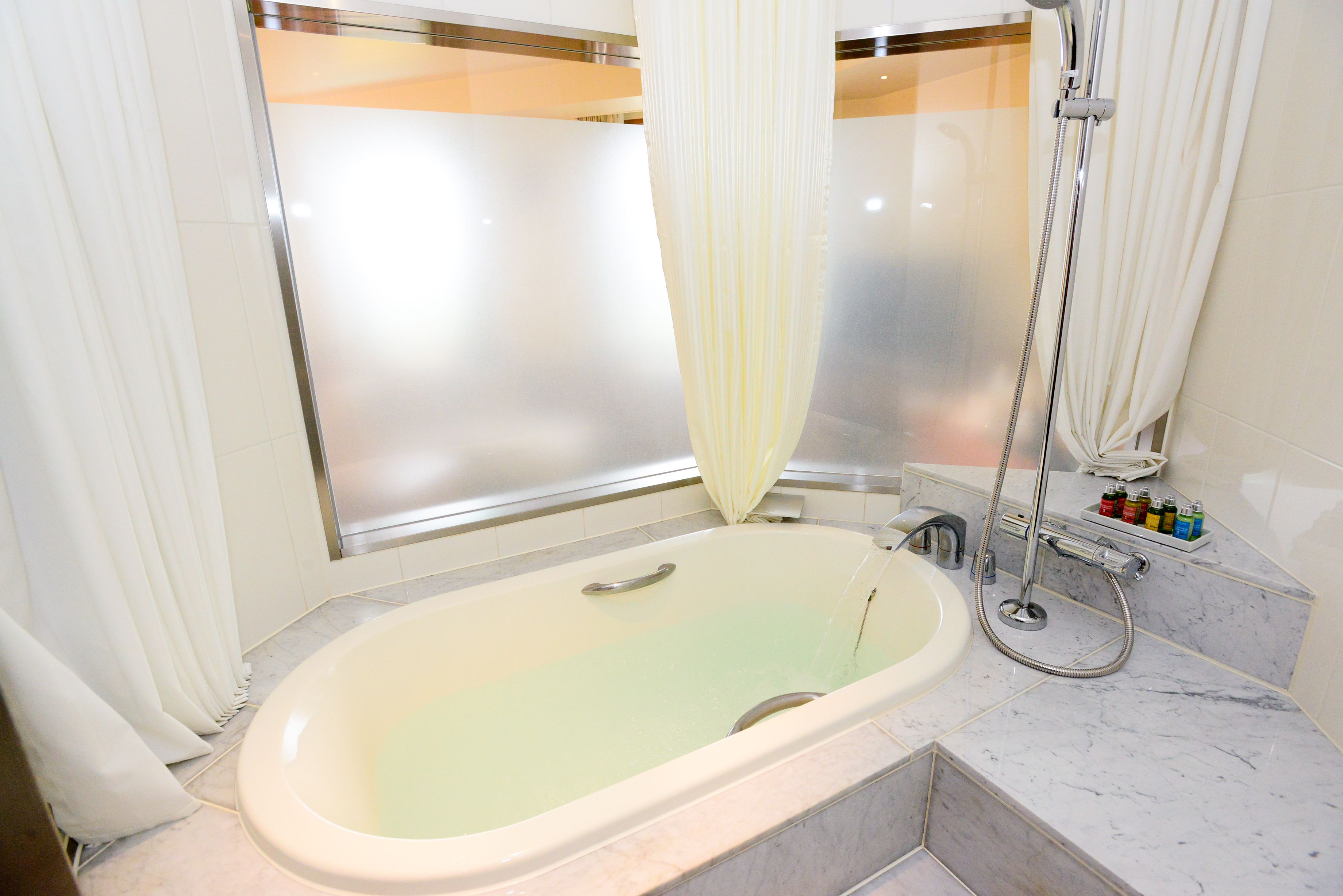 Un baño con bañera, ducha e inodoro.