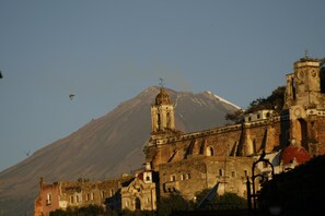 Stunning historic landmark with a prominent bell tower and large dome, situated in a mountainous region.