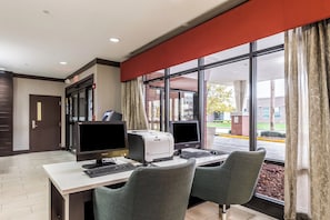 A hotel room with a desk, two monitors, a printer, and two chairs. - Holiday Inn Indianapolis Downtown by IHG (Indianapolis)