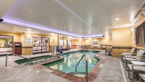An indoor swimming pool with a lifeguard station, lounge chairs, and a no diving sign. - Holiday Inn Indianapolis Downtown by IHG (Indianapolis)