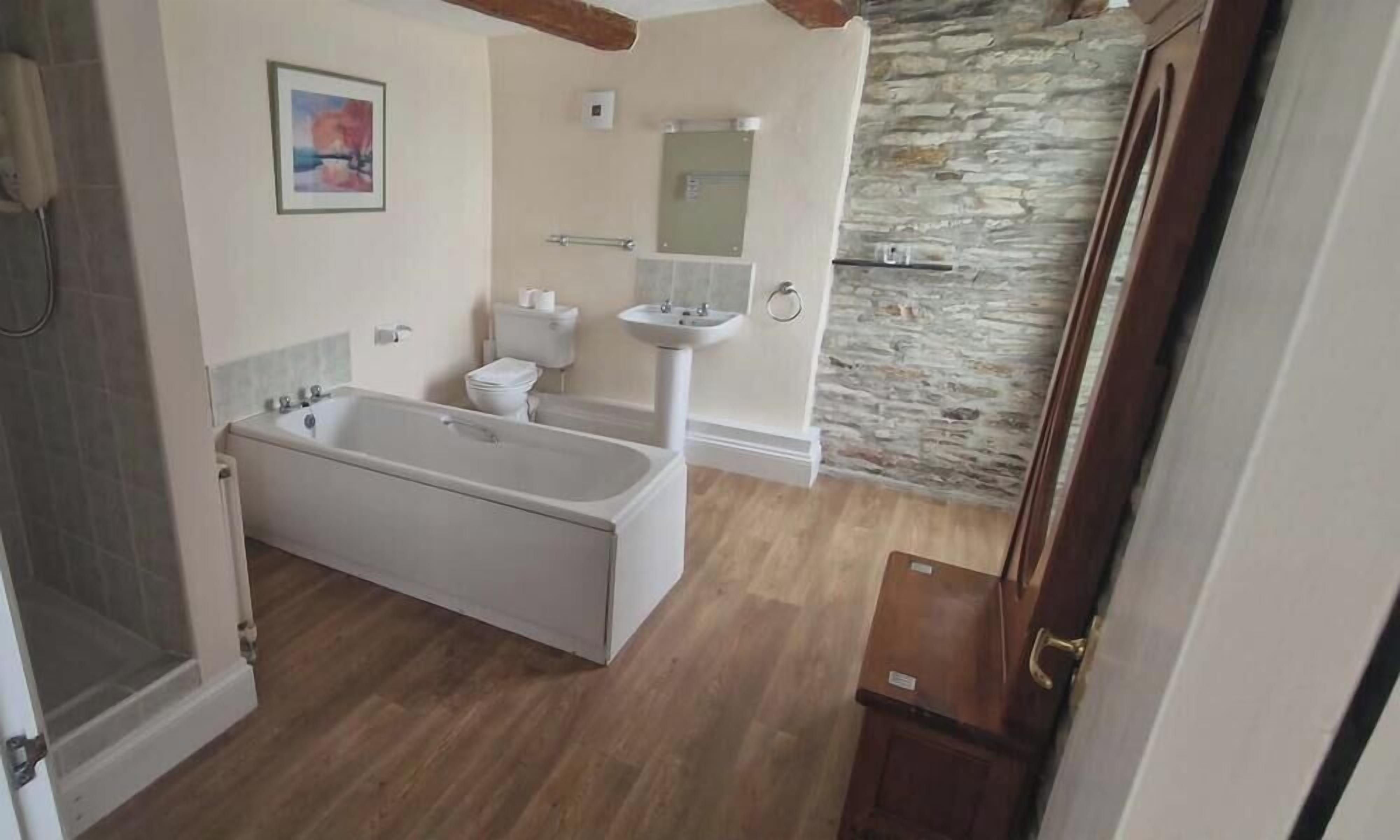Un baño con bañera, inodoro y lavamanos.