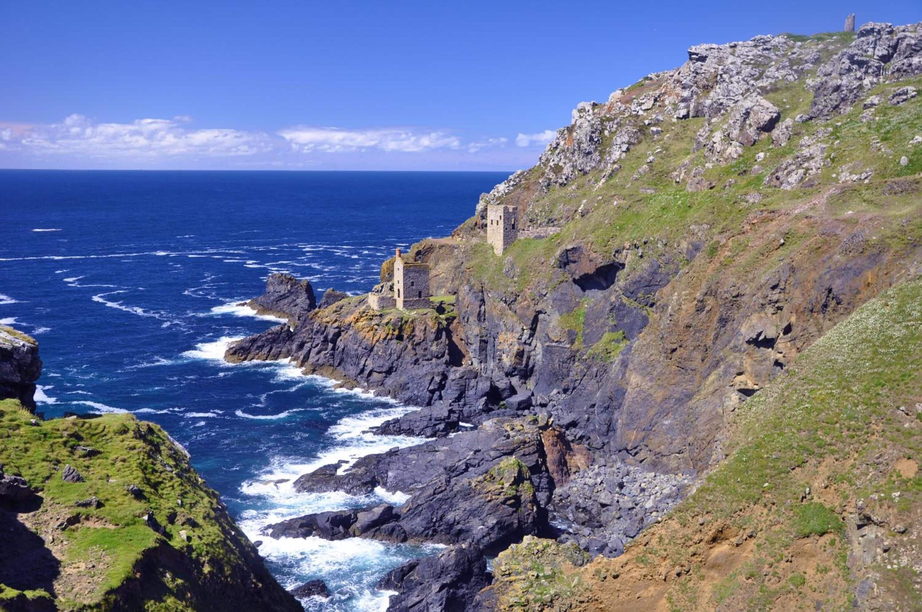 A coastal landscape with rocky cliffs and a sea view.