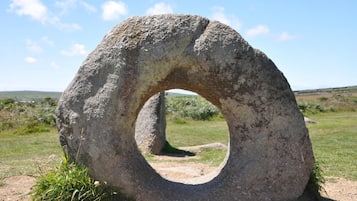 A large stone ring structure in an open field.