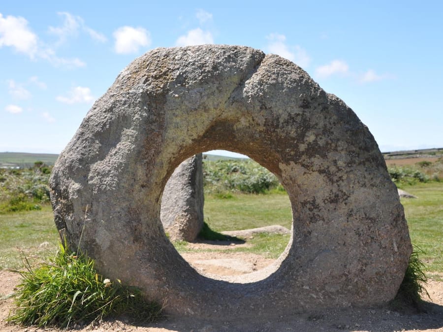 A large stone ring structure in an open field.