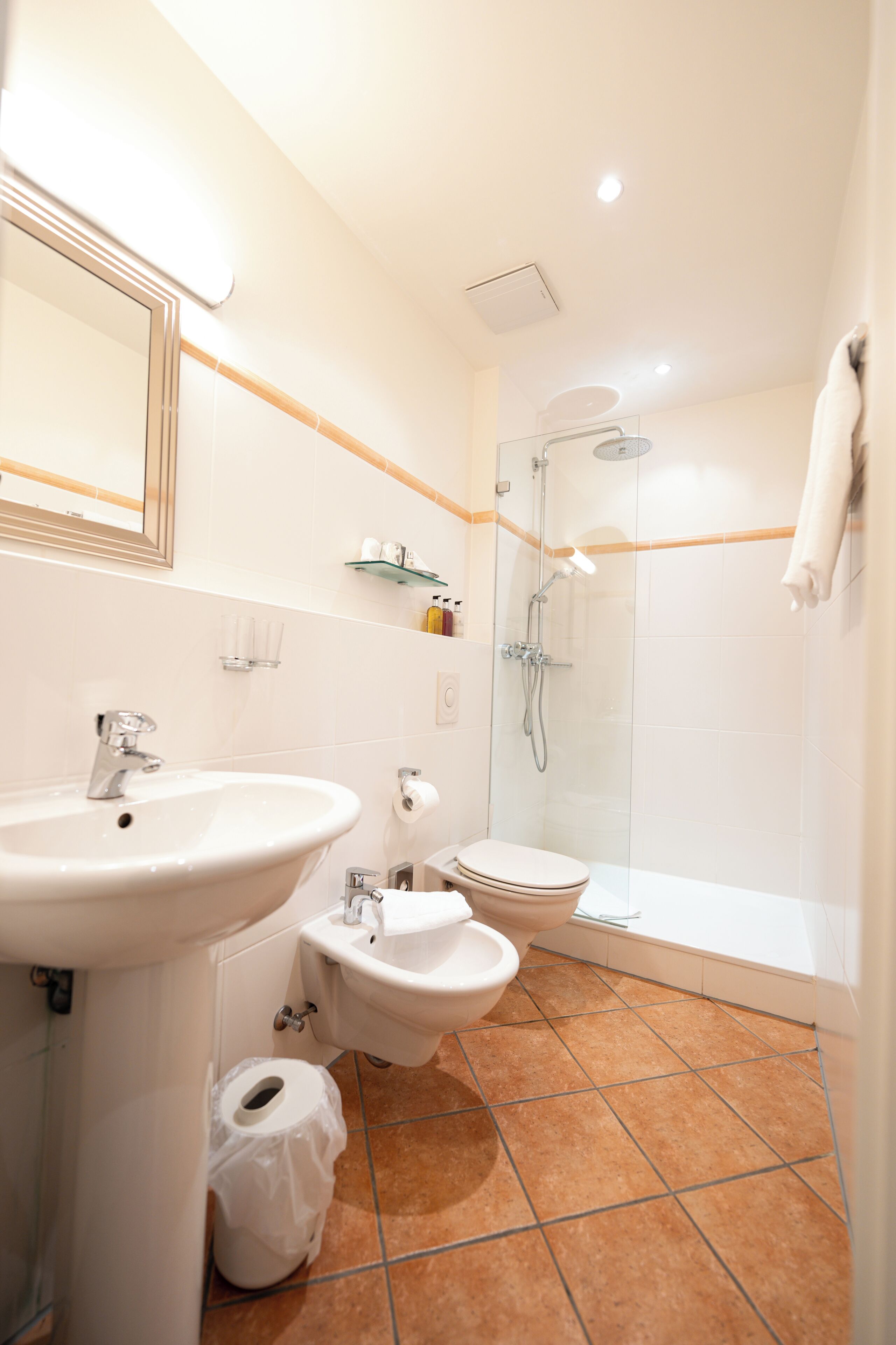 designer toiletries, hair dryer, bathrobes, slippers