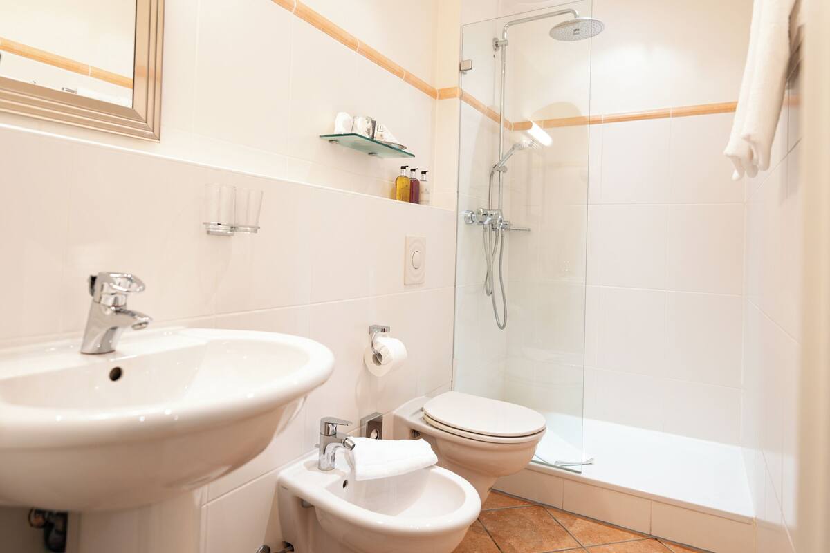 designer toiletries, hair dryer, bathrobes, slippers