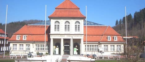 A large building with a red-tiled roof and a central entrance.