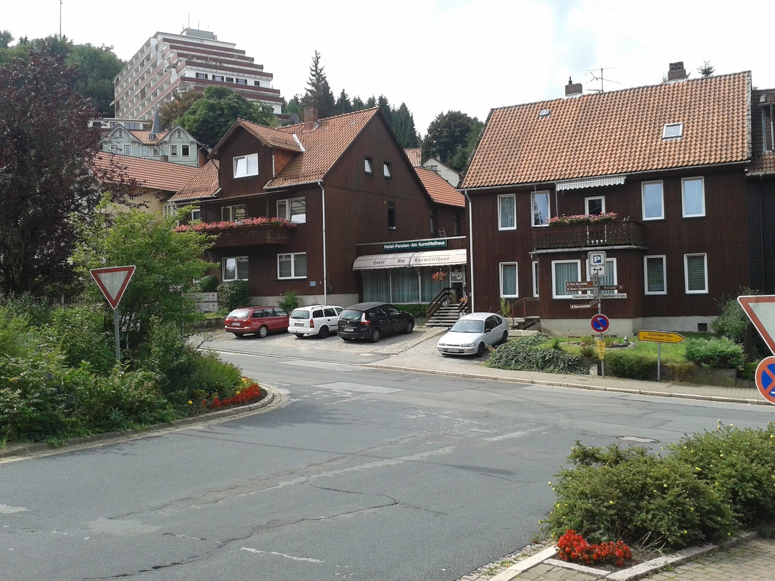 A hotel with a traditional European architectural style, featuring a red-tiled roof and a two-story structure.