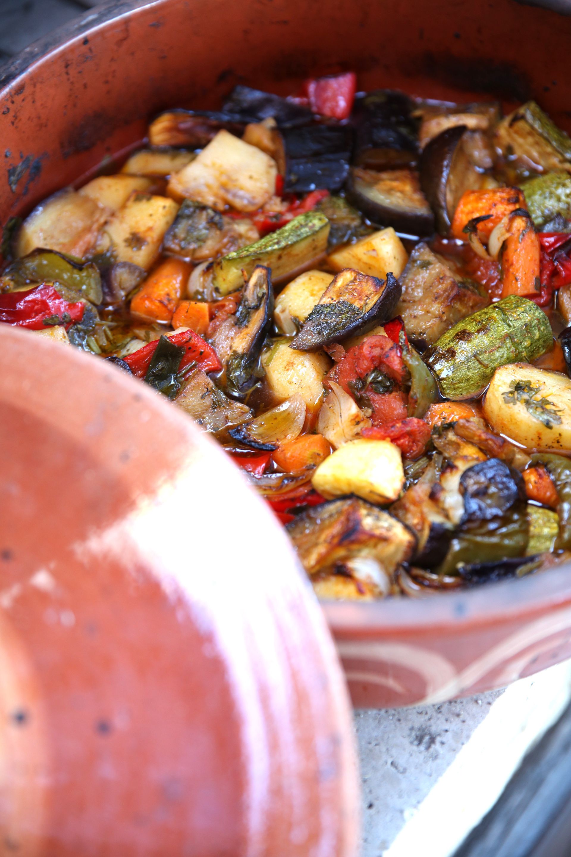A close-up of a dish with various vegetables and herbs.