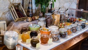 A buffet table with various food items and condiments. - Katalagari Country Suites (Archanes-Asterousia)