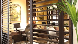 A home office with a desk, computer, and bookshelves. - The Eclipse Boutique Suites (Abu Dhabi)