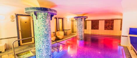 A spa area with mosaic pillars, a reception desk, and a reception area.