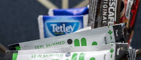 A collection of snack packages including Tetley tea, Nescafé Original, and semi skimmed milk.