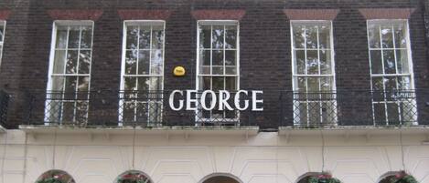 A building with a sign reading "GEORGE" above the entrance.