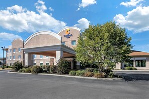 A Comfort Inn hotel with a modern design, featuring a covered entrance and well-maintained landscaping.