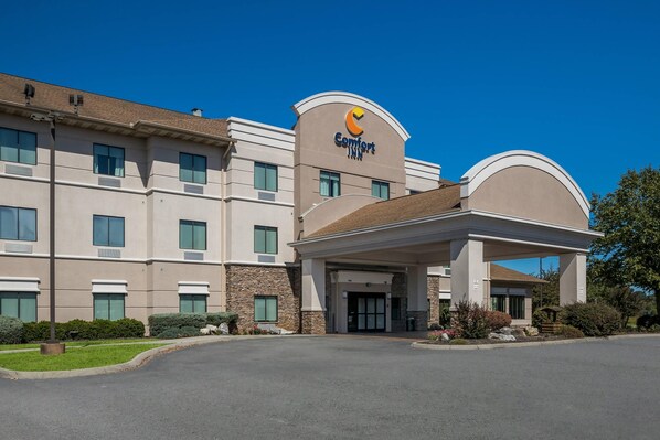 A Comfort Inn hotel with a modern design, featuring a central entrance and multiple windows.