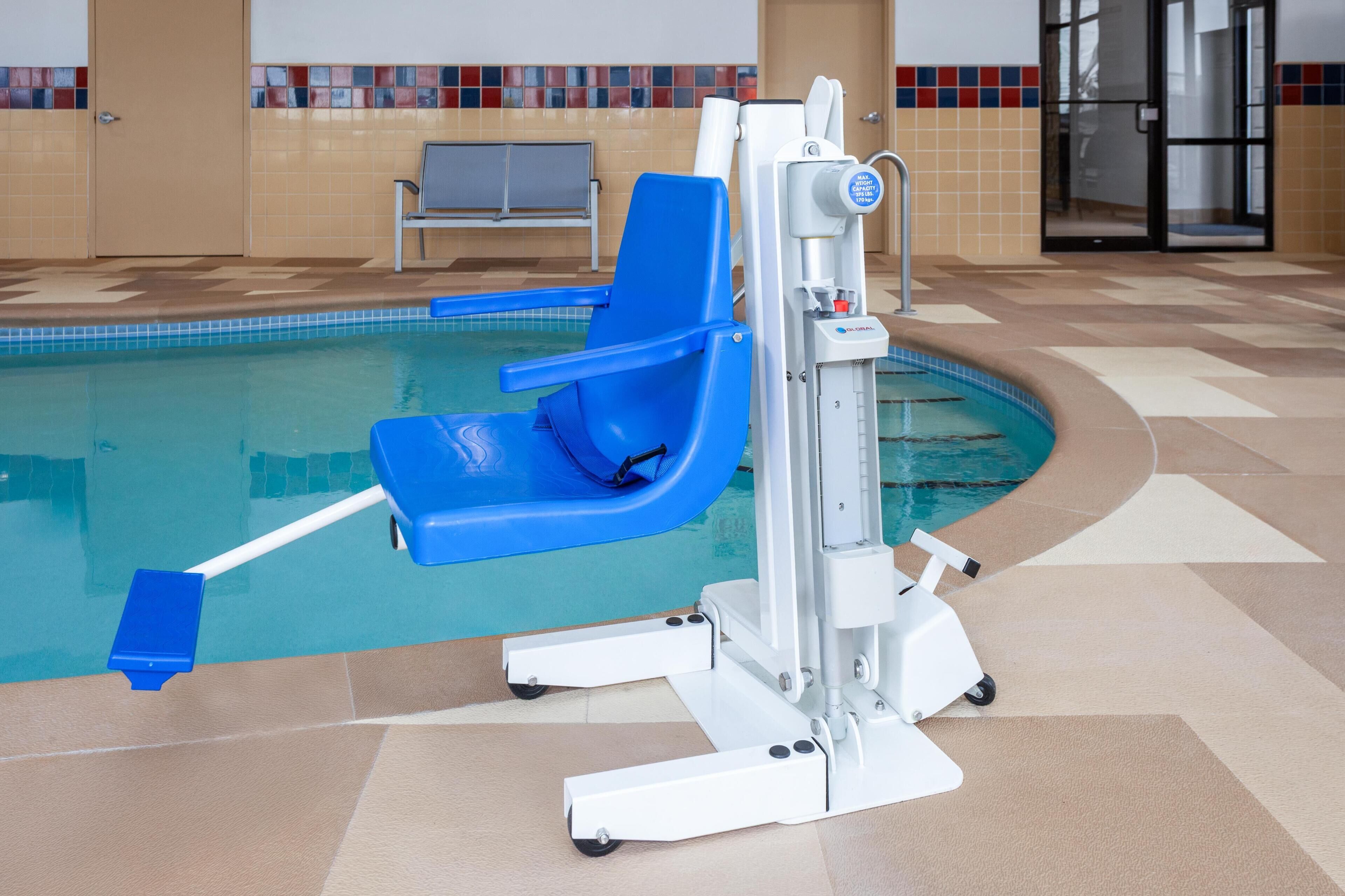 A pool area with a blue chair and a water slide.