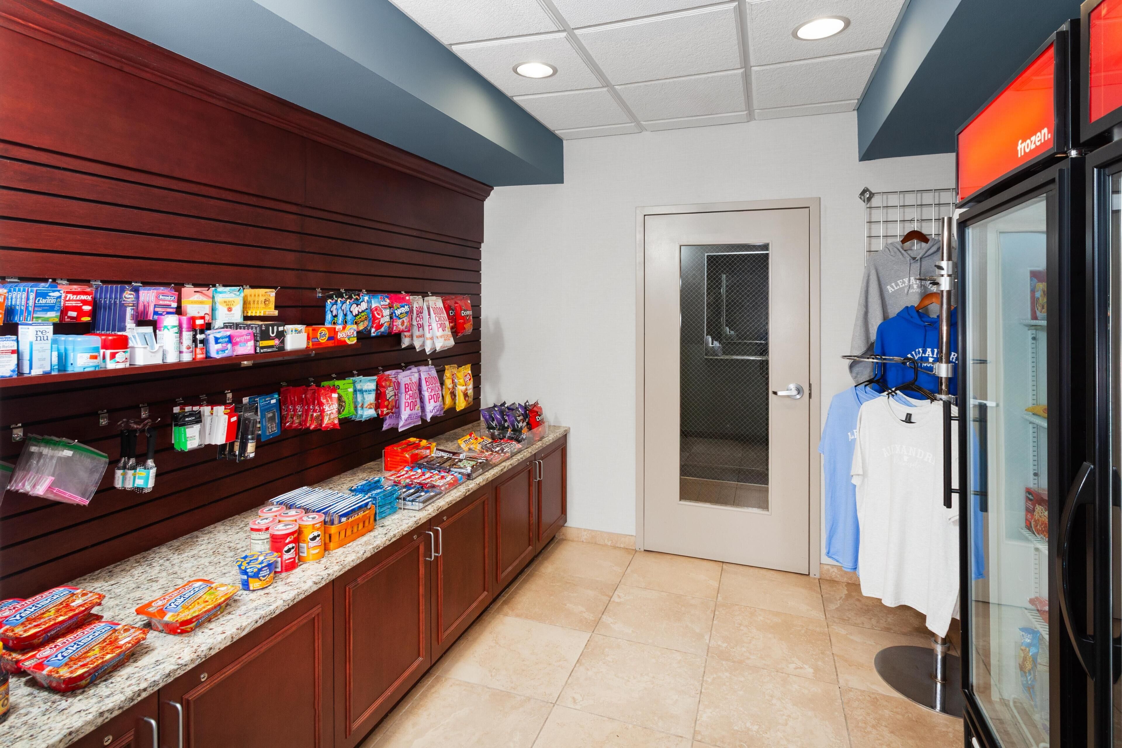 A grocery store with shelves stocked with snacks, beverages, and packaged goods.