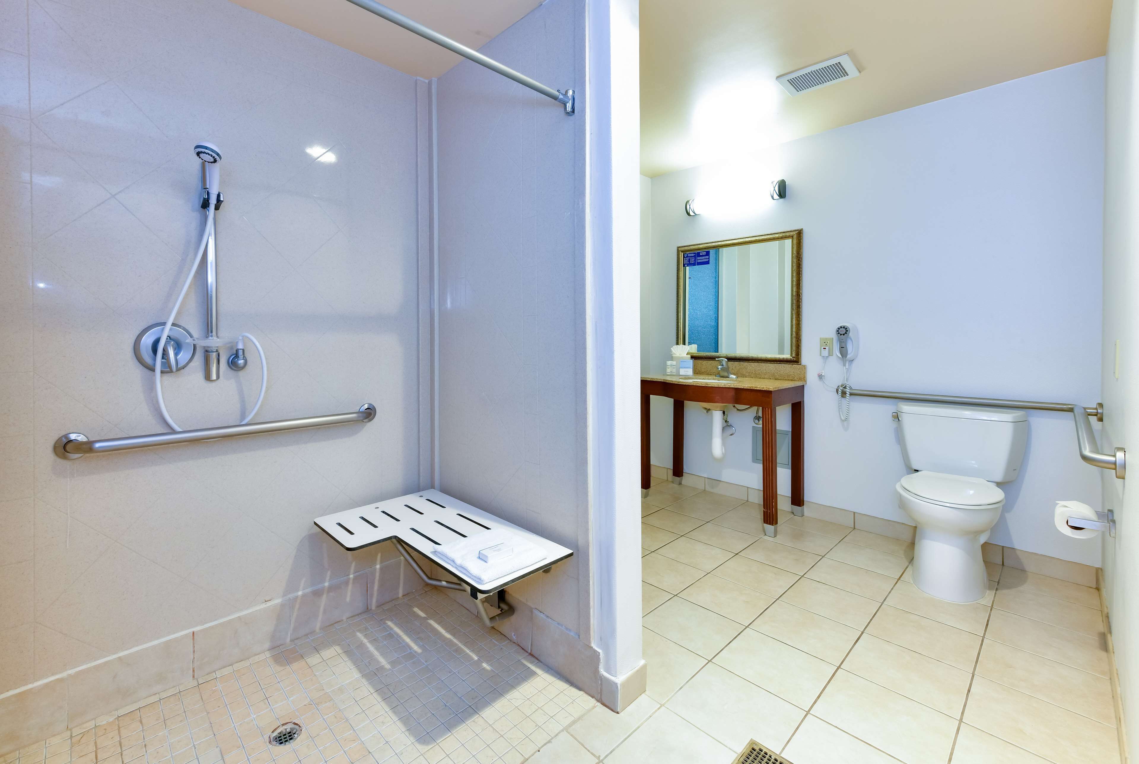 A bathroom with a shower, toilet, and sink.