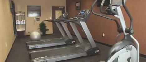 A fitness center with treadmills and an elliptical machine.