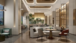 A modern interior with a central seating area, a kitchen in the background, and a dining area with tables and chairs.