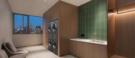 A modern kitchen with a large window, built-in appliances, and a city view.