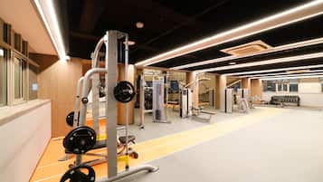 A gym with weightlifting equipment, cardio machines, and a track.