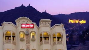 A hotel with a sign reading "Hotel Amar View" and a mountainous backdrop. - Hotel Amer View (Amer)