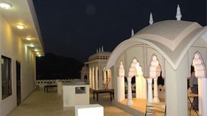 A corridor with a series of arches and columns, leading to a seating area. - Hotel Amer View (Amer)