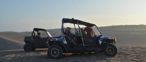 Two off-road vehicles on a sandy terrain.