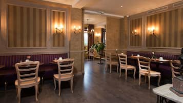 A restaurant with wooden chairs and tables, striped wall panels, and wall-mounted lighting fixtures.