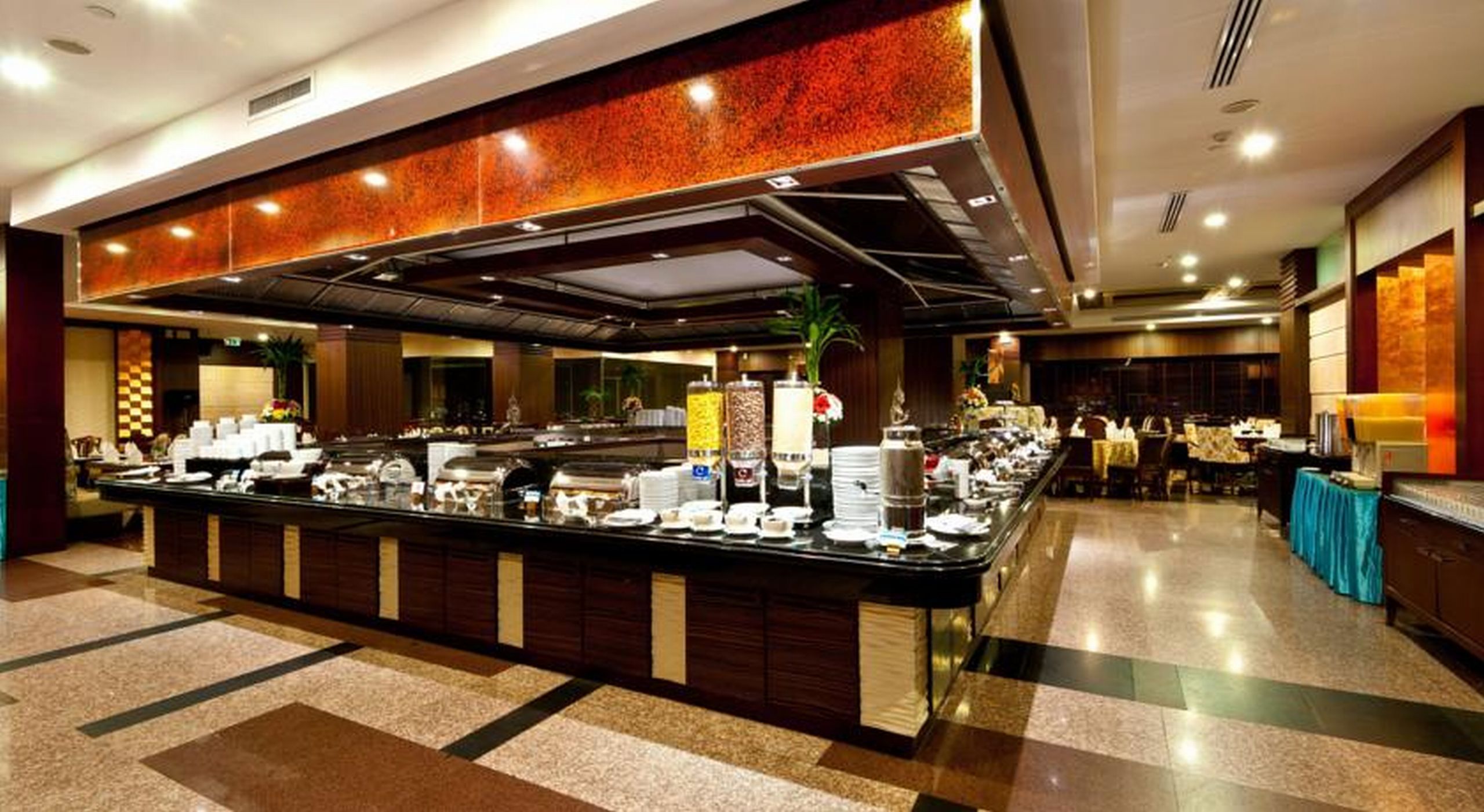 A buffet setup with various food items and a central serving area.