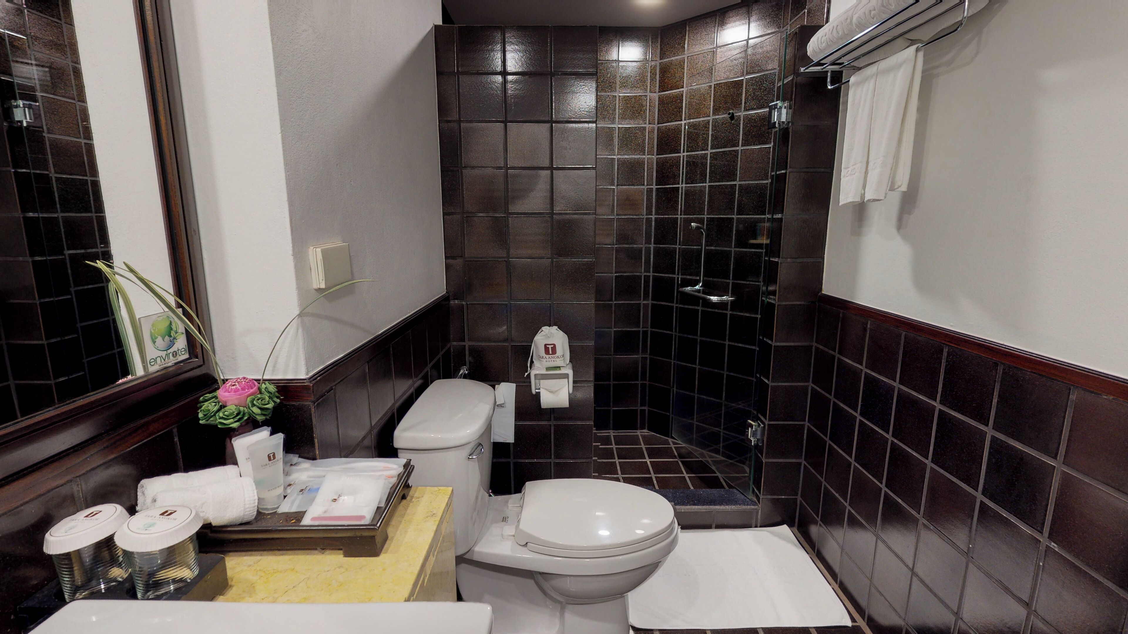 A compact bathroom with a toilet, bidet, and sink.