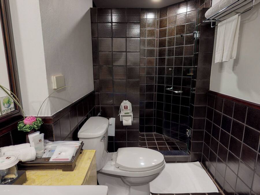 A compact bathroom with a toilet, bidet, and sink.